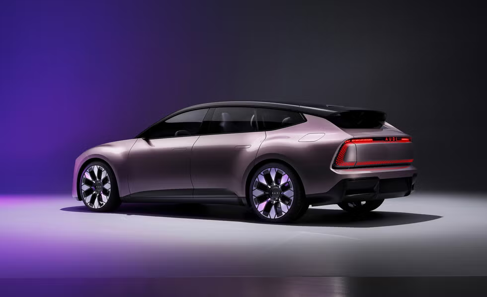 Audi electric vehicle concept shown in profile in a purple-lit studio.